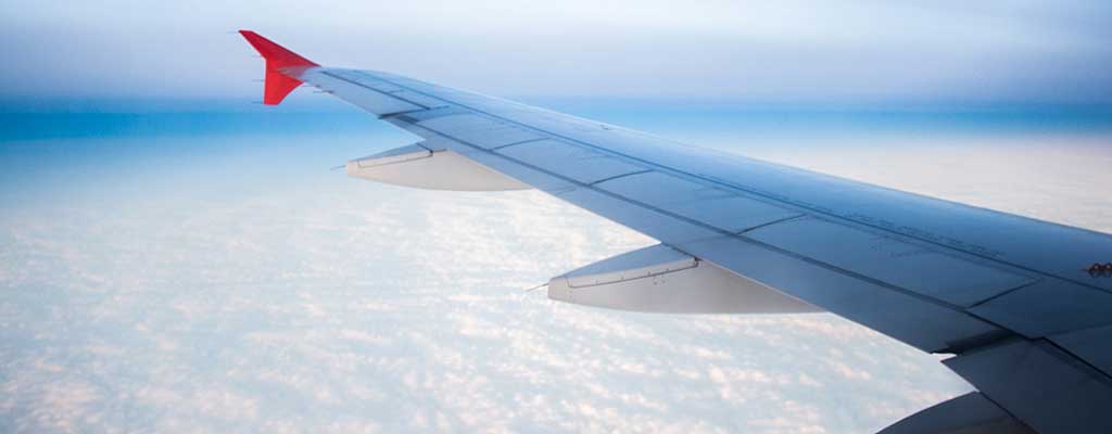 aircraft wing plane over clouds