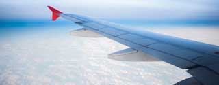 aircraft wing plane over clouds